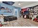 Cozy bedroom featuring light blue walls, wood-look flooring, ceiling fan, and a window at 8248 S Yantley Ct, Aurora, CO 80016