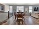 Dining area features wood floors, natural light, and a large table perfect for entertaining at 8248 S Yantley Ct, Aurora, CO 80016
