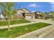 Home's exterior showcasing well-kept lawn, stone accents, and a three-car garage at 8248 S Yantley Ct, Aurora, CO 80016