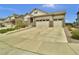 Charming home featuring a three car garage, stone accents, and well-manicured landscaping at 8248 S Yantley Ct, Aurora, CO 80016