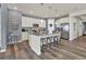 Modern kitchen featuring stainless steel appliances, a large island with seating, and pendant lighting at 8248 S Yantley Ct, Aurora, CO 80016