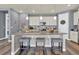 Beautiful kitchen featuring island seating, stainless appliances, and stylish pendant lighting at 8248 S Yantley Ct, Aurora, CO 80016
