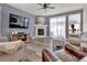 Cozy living room with a stone fireplace, plush seating, and ample natural light at 8248 S Yantley Ct, Aurora, CO 80016