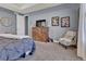 Comfortable main bedroom featuring a tv on a wood dresser and a cozy chair at 8248 S Yantley Ct, Aurora, CO 80016
