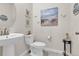 Charming powder room with coastal-inspired decor, stylish fixtures, and vanity sink at 8248 S Yantley Ct, Aurora, CO 80016