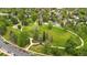 Aerial view of lush green park with walking paths, mature trees, and vibrant green space for outdoor recreation at 3050 W 32Nd Ave # 202C, Denver, CO 80211