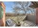 Charming balcony with a chair, stool and views of the surrounding neighborhood at 3050 W 32Nd Ave # 202C, Denver, CO 80211