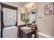 Well-lit bathroom with stackable washer/dryer unit and stylish decor at 3050 W 32Nd Ave # 202C, Denver, CO 80211