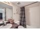 Cozy bathroom featuring a tub with a patterned shower curtain and a sink with vanity in a well-lit space at 3050 W 32Nd Ave # 202C, Denver, CO 80211