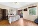 Bedroom featuring hardwood floors, a full-sized bed, access to a balcony, and large windows at 3050 W 32Nd Ave # 202C, Denver, CO 80211