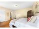 Bedroom with neutral walls, hardwood floors, and ensuite bathroom at 3050 W 32Nd Ave # 202C, Denver, CO 80211