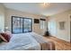 Comfortable bedroom with a balcony, wood floors and natural light at 3050 W 32Nd Ave # 202C, Denver, CO 80211