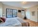 Bedroom featuring sliding glass doors, wood floors and natural light at 3050 W 32Nd Ave # 202C, Denver, CO 80211