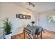 Cozy dining area with a table set for two and a gallery wall at 3050 W 32Nd Ave # 202C, Denver, CO 80211