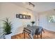 Bright dining area with hardwood floors, a table with chairs, and a decorative plant at 3050 W 32Nd Ave # 202C, Denver, CO 80211