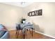Dining room with table and chairs, modern art, and wood laminate flooring at 3050 W 32Nd Ave # 202C, Denver, CO 80211