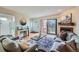 Bright living room with fireplace, stylish decor, and sliding glass doors to a cozy balcony at 3050 W 32Nd Ave # 202C, Denver, CO 80211