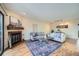 Cozy living room with a fireplace, plush sofas, area rug, and bright natural light at 3050 W 32Nd Ave # 202C, Denver, CO 80211