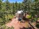 An aerial view of a home's two-car garage surrounded by lush green trees at 6100 Apache Dr, Larkspur, CO 80118
