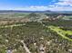 Stunning aerial view of a community nestled amongst lush forests and rolling hills at 6100 Apache Dr, Larkspur, CO 80118