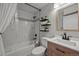Modern bathroom featuring a shower-over-tub with white subway tile, and a decorative shelf with plants at 6100 Apache Dr, Larkspur, CO 80118