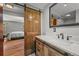 Bathroom with modern fixtures, vanity and barn door entrance to bedroom at 6100 Apache Dr, Larkspur, CO 80118