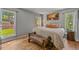 Serene bedroom with natural light and hardwood floors at 6100 Apache Dr, Larkspur, CO 80118