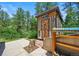 Unique backyard shed surrounded by lush greenery and a well-maintained outdoor space at 6100 Apache Dr, Larkspur, CO 80118