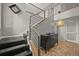 Modern foyer with sleek black and metal staircase, wood floors, and stylish decor at 6100 Apache Dr, Larkspur, CO 80118