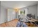 Bright home office featuring hardwood floors, two monitors, and a large window with a view at 6100 Apache Dr, Larkspur, CO 80118