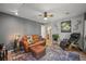 Cozy living room boasts a comfortable leather sofa, a large window, and stylish decor at 6100 Apache Dr, Larkspur, CO 80118
