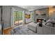 Living room with cozy fireplace and access to the outdoor deck at 6100 Apache Dr, Larkspur, CO 80118