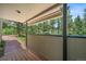 Inviting covered patio with scenic views of lush greenery and serene trees in a tranquil backyard setting at 6100 Apache Dr, Larkspur, CO 80118