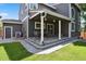 Back exterior of home featuring a covered patio, brick paver flooring, and green lawn at 19653 E Ida Dr, Aurora, CO 80015