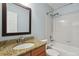 Bathroom features a single sink vanity, toilet, and shower-tub combo at 19653 E Ida Dr, Aurora, CO 80015