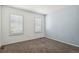 Bedroom with plush carpet, window with shutters, and painted blue accent wall at 19653 E Ida Dr, Aurora, CO 80015