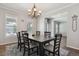 Formal dining room features a chandelier, large windows, and an adjacent doorway at 19653 E Ida Dr, Aurora, CO 80015