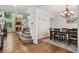 Elegant dining room showcasing hardwood floors, chandelier, and seamless transition to the living area at 19653 E Ida Dr, Aurora, CO 80015