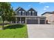 Beautiful two-story home featuring a three car garage, manicured lawn, and charming curb appeal at 19653 E Ida Dr, Aurora, CO 80015