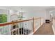 Hallway overlooking a living room with fireplace at 19653 E Ida Dr, Aurora, CO 80015