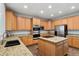 This large kitchen features wood cabinets, granite countertops, stainless steel appliances, and center island at 19653 E Ida Dr, Aurora, CO 80015