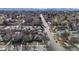 An aerial view of a neighborhood with tree-lined streets and a skyline in the distance at 1166 Krameria St, Denver, CO 80220