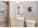 This bathroom features neutral tile, a round bowl sink, and a walk-in shower at 1166 Krameria St, Denver, CO 80220