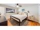Cozy bedroom with hardwood floors, ceiling fan, and bright window for natural light at 1166 Krameria St, Denver, CO 80220