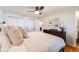 A cozy bedroom with a ceiling fan, a window, and a view into an attached bathroom at 1166 Krameria St, Denver, CO 80220