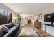 Bright living room features hardwood floors, large window, and comfortable seating area at 1166 Krameria St, Denver, CO 80220