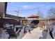 Relaxing patio with outdoor seating, fire pit, grill, string lights, and an orange umbrella at 1166 Krameria St, Denver, CO 80220