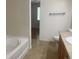 Clean bathroom featuring a tub and wood vanity at 9300 E Florida Ave # 608, Denver, CO 80247