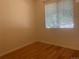 Cozy bedroom with wood-look floors and window at 9300 E Florida Ave # 608, Denver, CO 80247