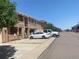 Exterior view of townhomes in a row with reserved parking in front under a clear blue sky at 9300 E Florida Ave # 608, Denver, CO 80247